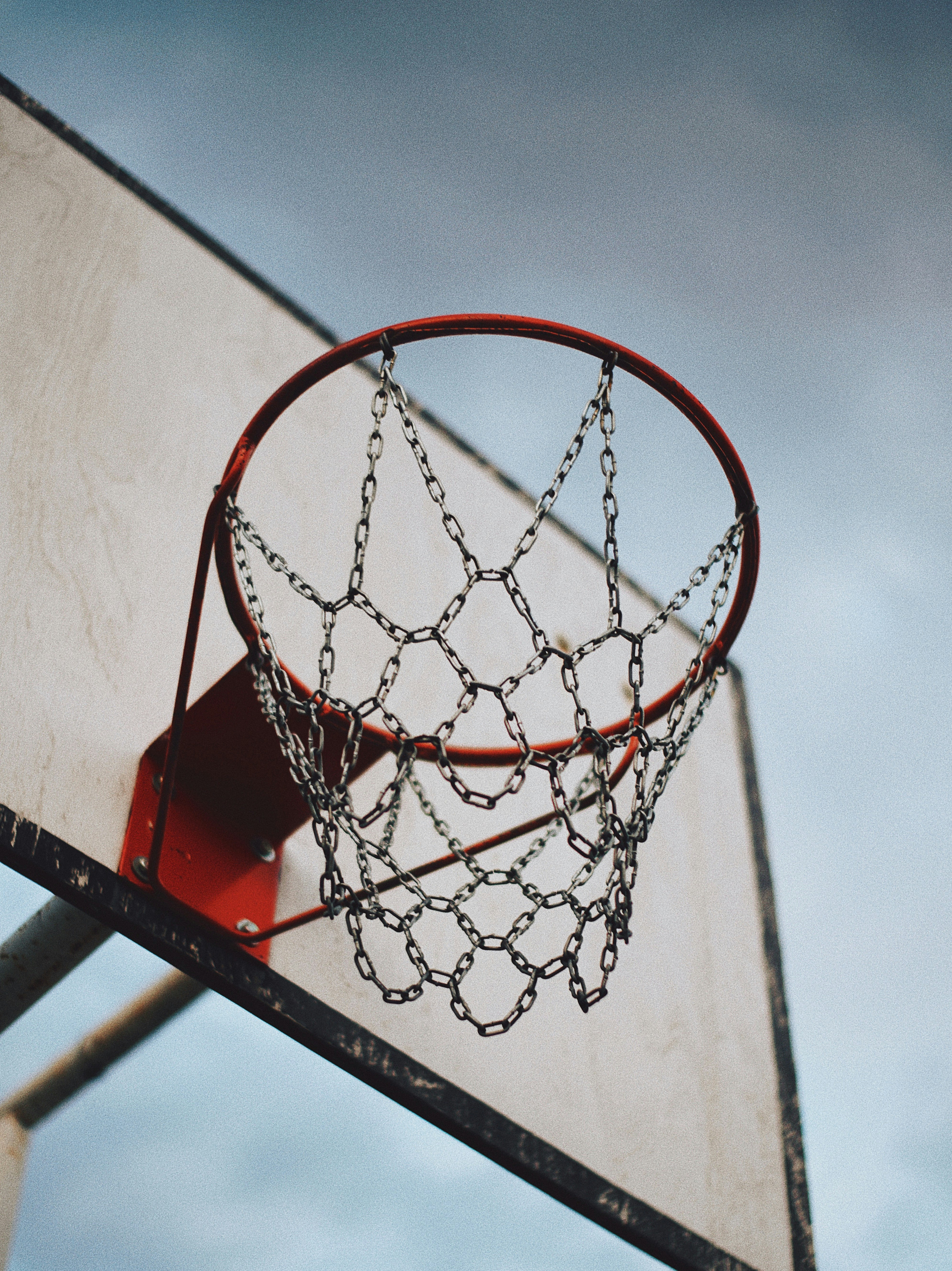 red basketball hoop under white sky during daytime